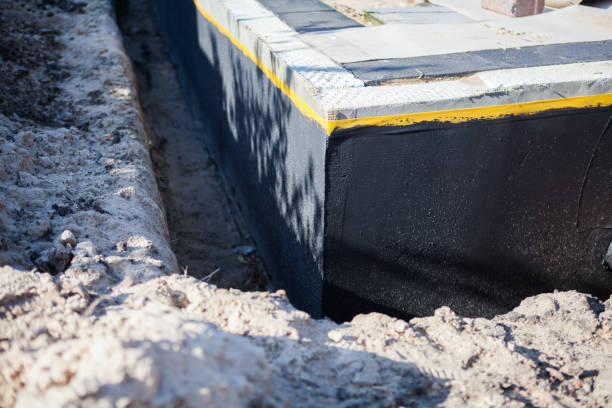 Professional Basement Waterproofing technician working in Spencerville, MD